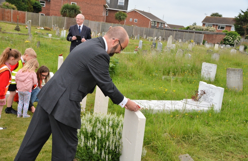 James laying a poppy on Commonwealth war grave