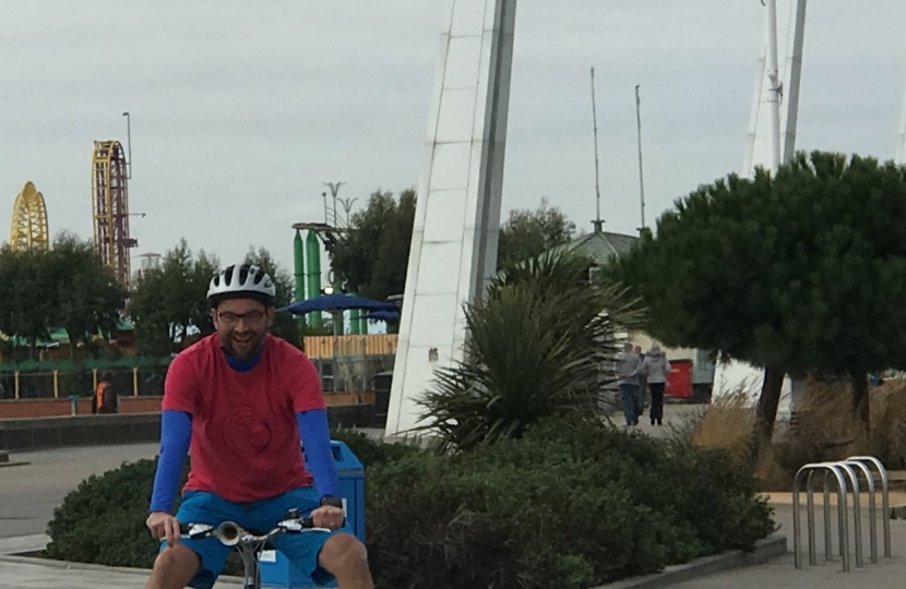 James riding his bike through the seafront fountains
