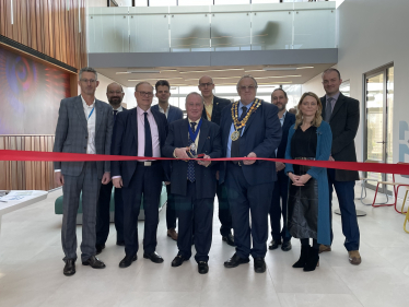 Photo of Sir James Duddridge KCMG MP alongside representatives from Southend City Council, Rochford District Council, South East Essex Local Enterprise Partnership and Oxford Innovation Space, cutting the ribbon. 